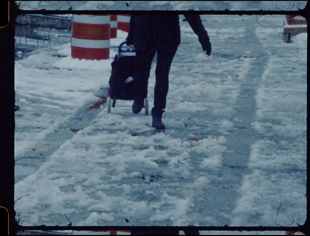 A person pulls a cart over snow and ice