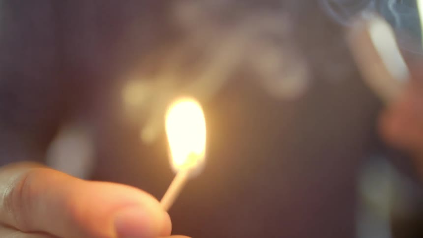 A person striking a match