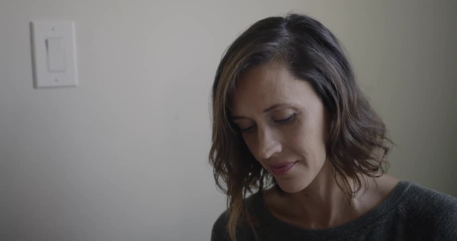 A woman smiles at home