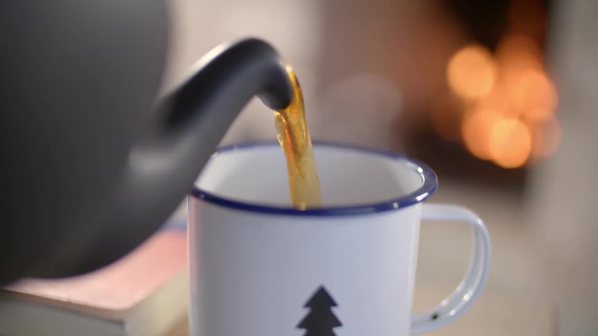A mug is being filled with tea