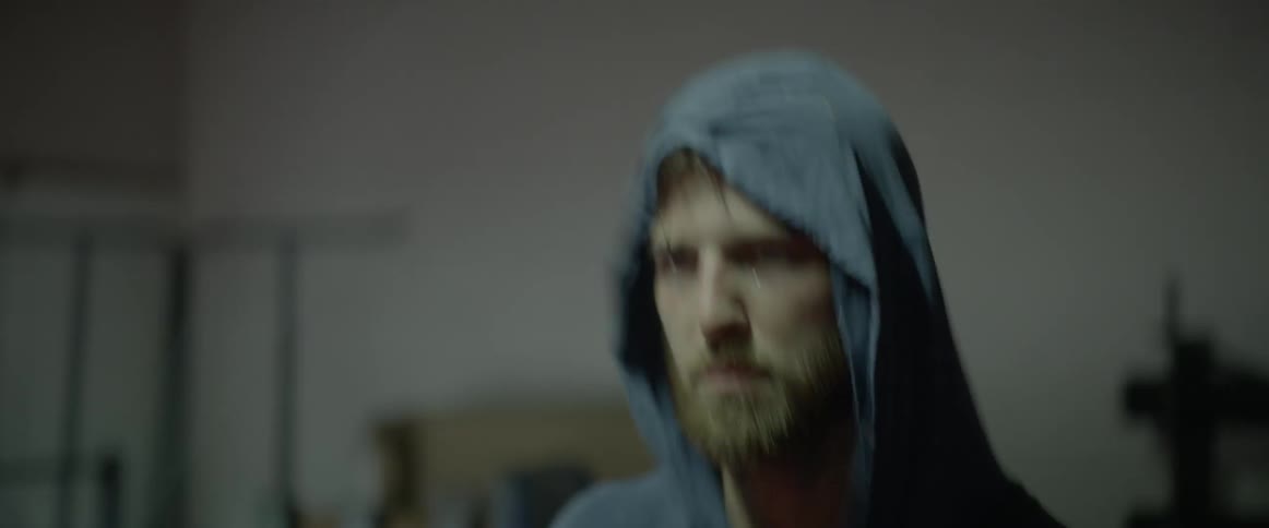 Man wears hooded shirt while jumping rope