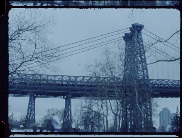 The large bridge runs into the cloudy sky