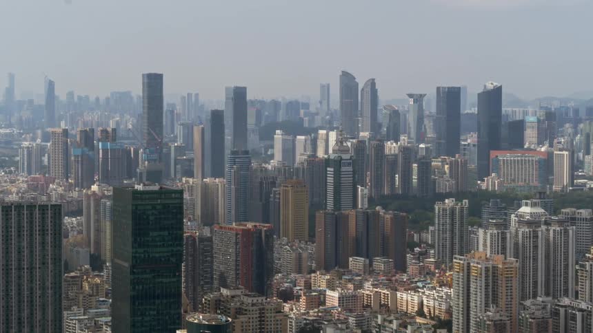 City buildings stand tall under a blue sky