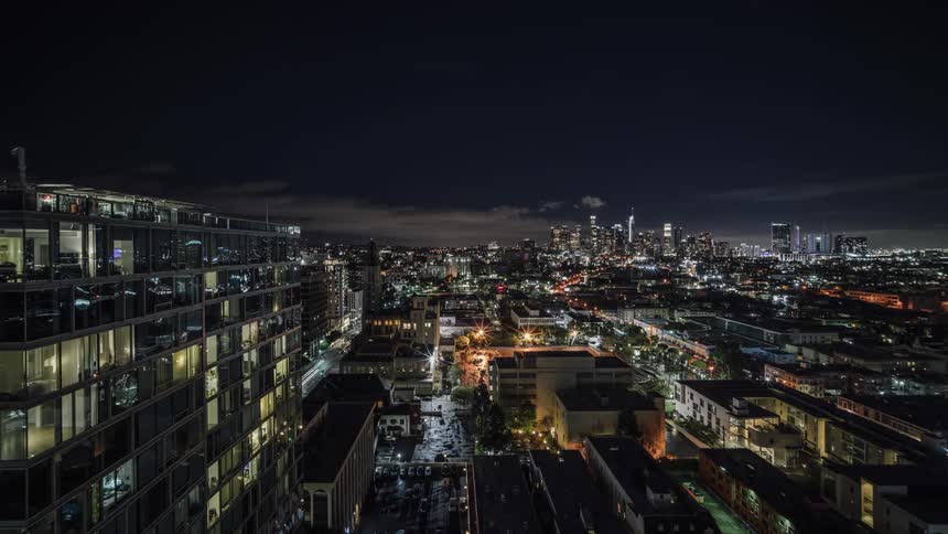 Large city lit up at night by lights of buildings and traffic