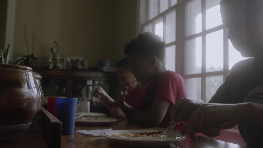 Children sit together eating food