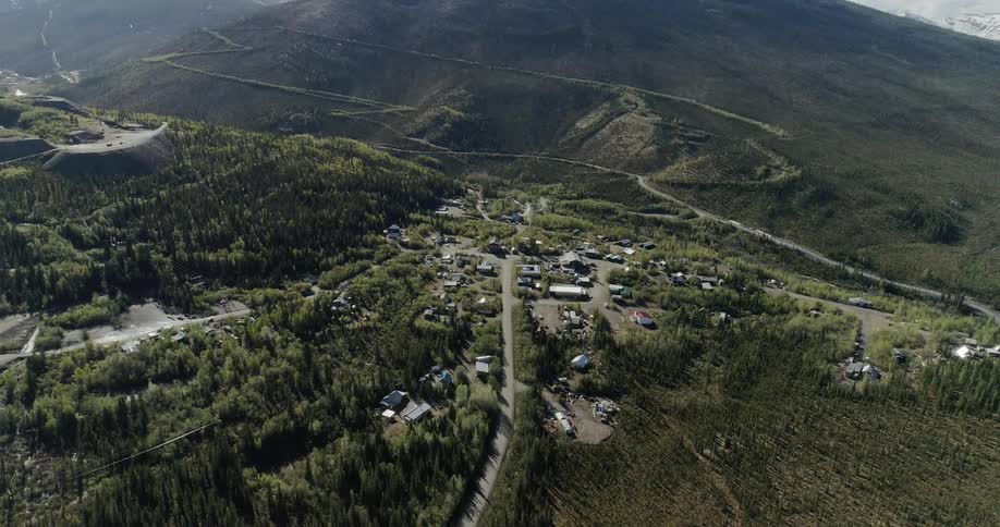 Buildings sit in a mountain forest