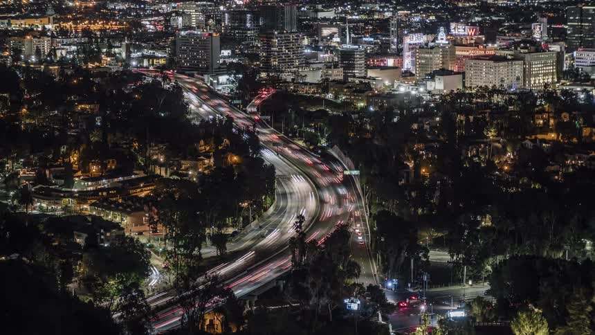 The highway splits off into the city at night