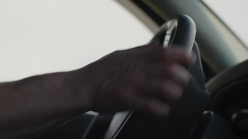 A man turns the steering wheel