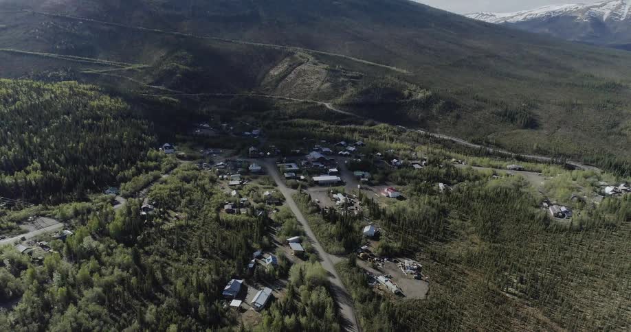Buildings are surrounded by trees and mountains