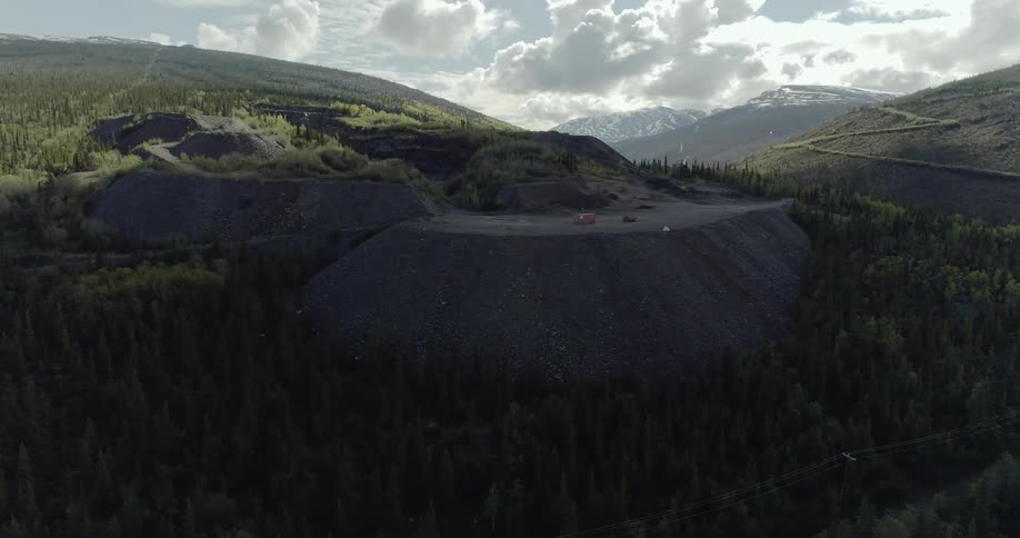 The cliff has cars parked all around the top
