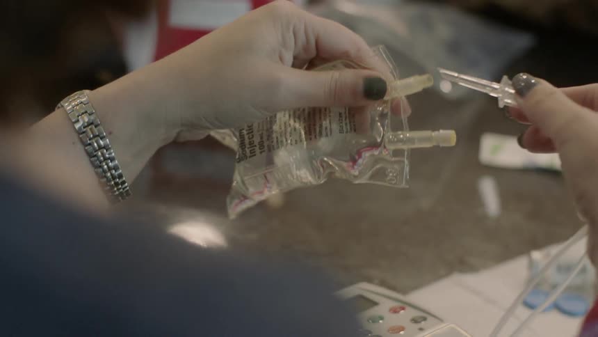 A nurse is preparing an iv bag
