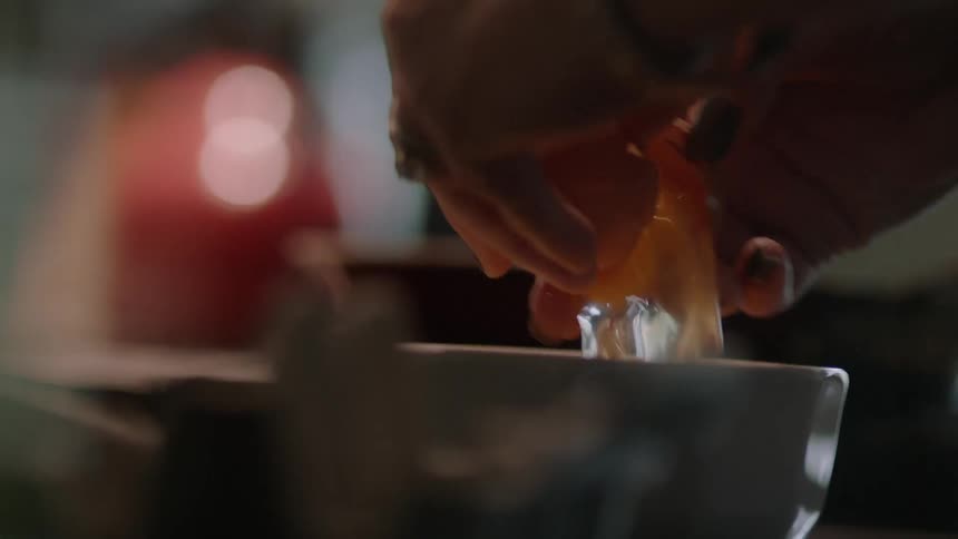A person is cooking with eggs in the kitchen