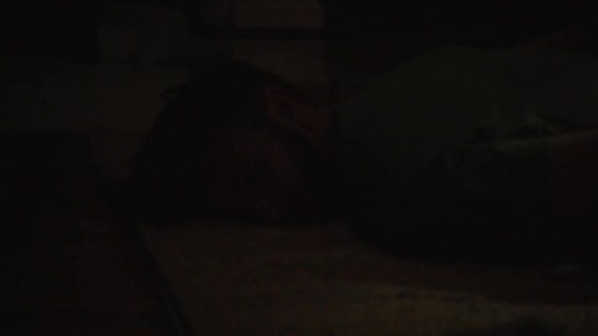 People are laying on the floor handcuffed as officers search the place