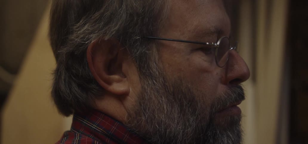 A man with a beard wearing eyeglasses