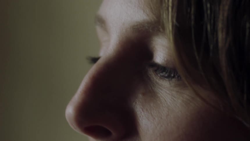 A woman's face in profile as she talks