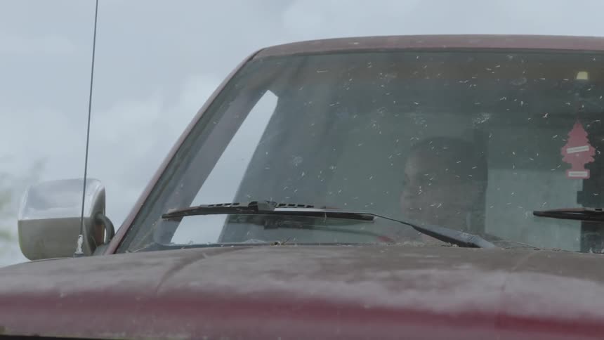 A child talks with someone in the moving truck