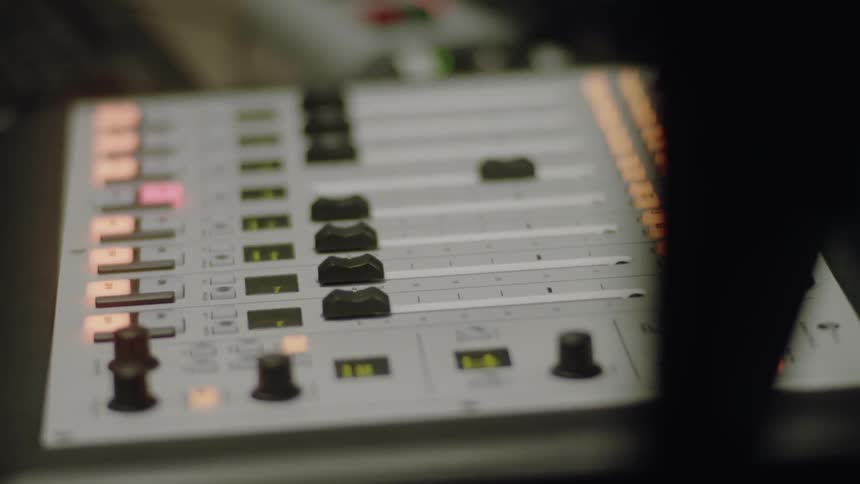 The mixer has many dials and lights on it