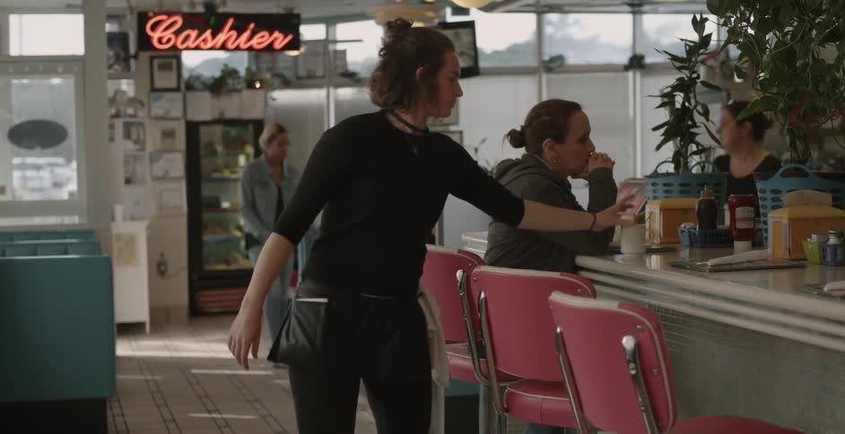 A busy diner with servers and customers
