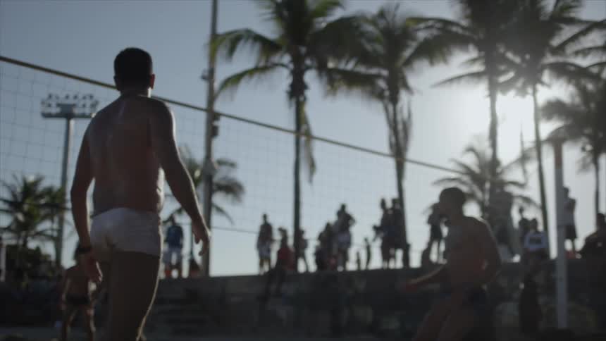 People are playing volleyball on a sunny day