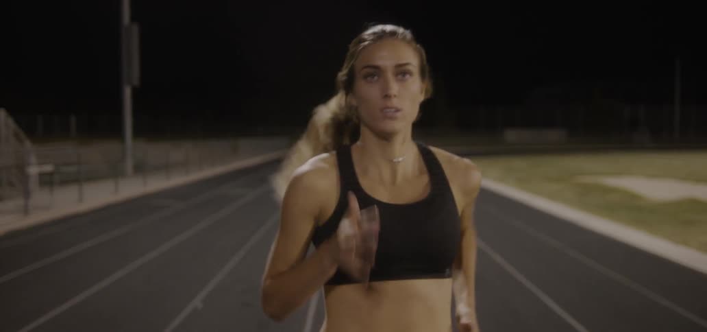 Woman is running on track at night