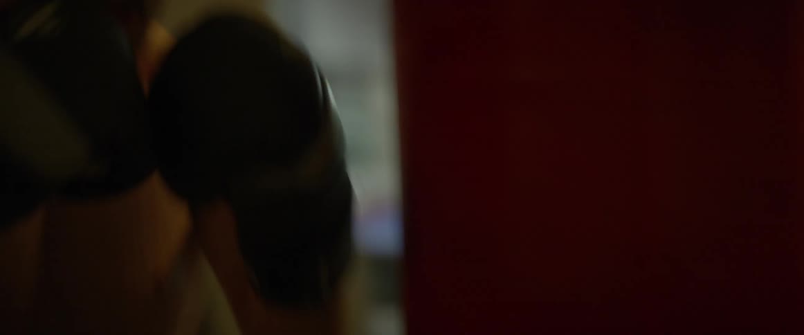 A boxer hits a punching bag