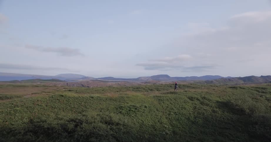 A person walks along the top of a hill