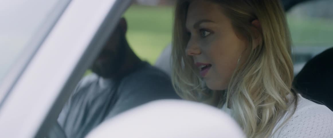 Woman drives a car as a man sits in the passenger seat