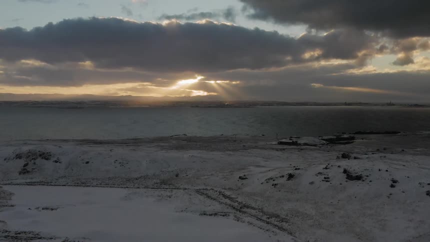 Snow covers the majority of the stone mountains