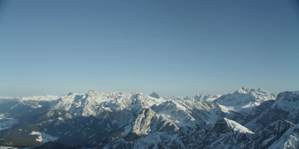 Blue sky over snow covered mountain peaks