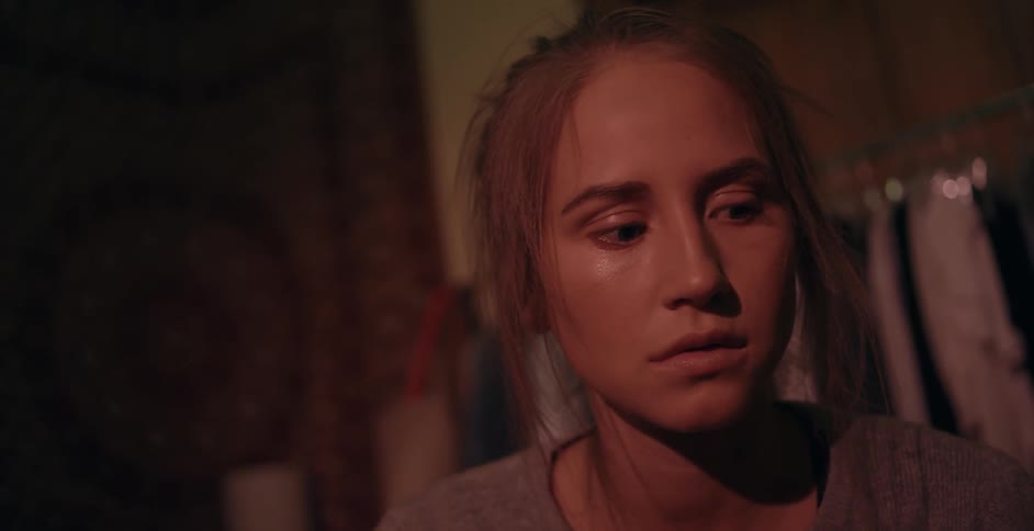 A girl looks around in the dark room