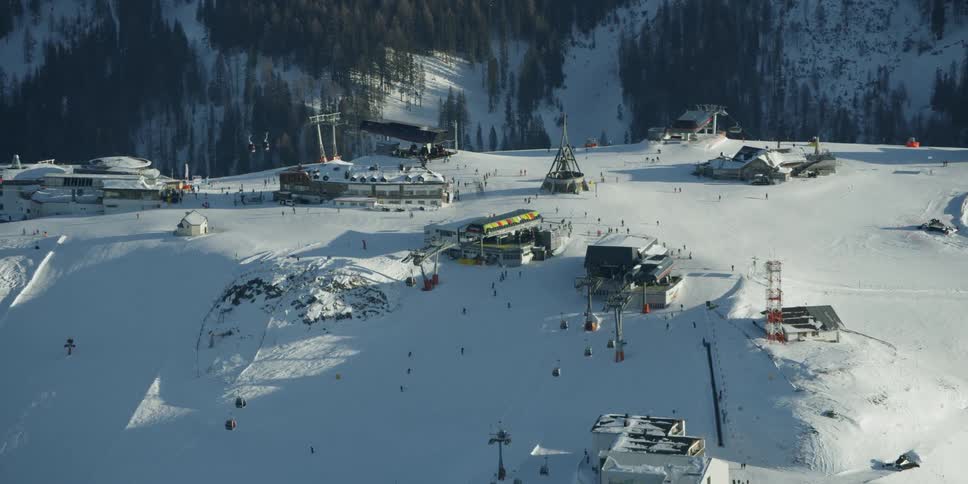 A ski resorts sits on a mountain peak
