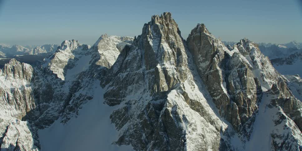 The tall mountains reach the sunny sky