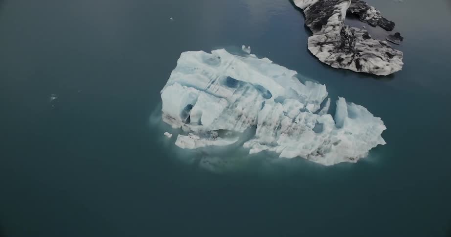 An iceberg floats in water