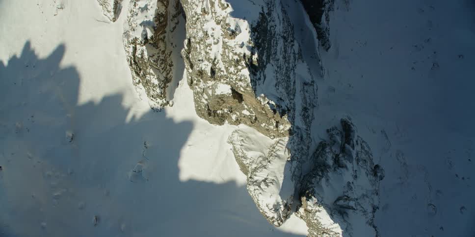 Jagged rocks on top of snow covered mountain