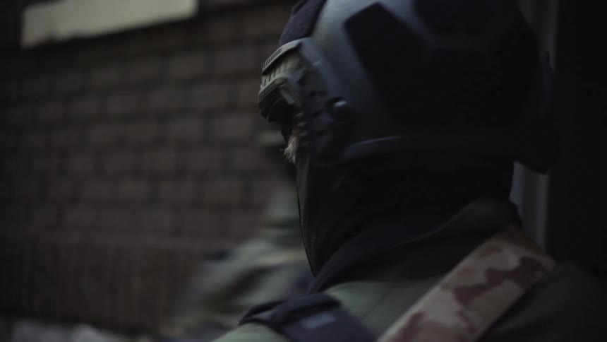 A swat team enters a building