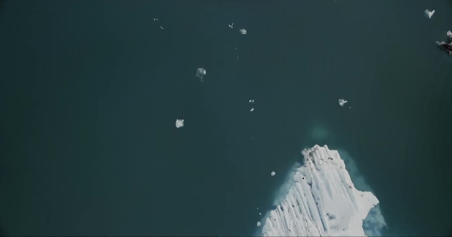 Icebergs are floating in the ocean in daylight