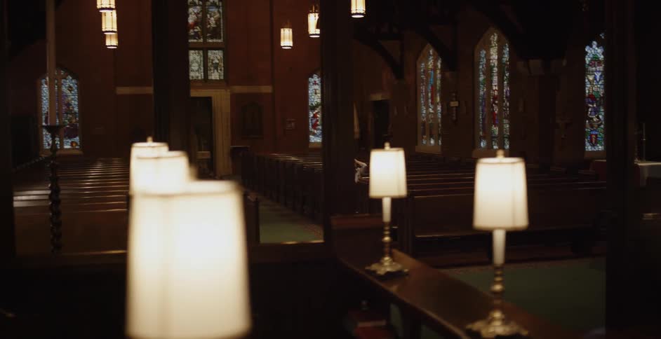 A woman sits inside a church