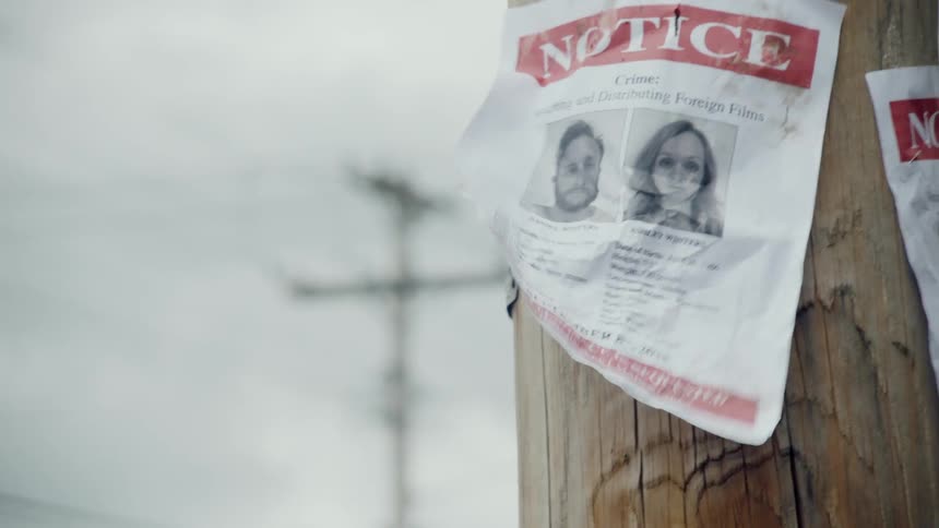 A wanted sign hangs on a telephone pole