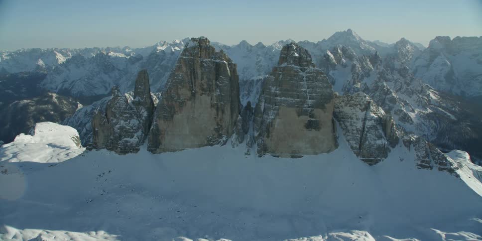 Tall jagged rock formations coming out of snow on mountain