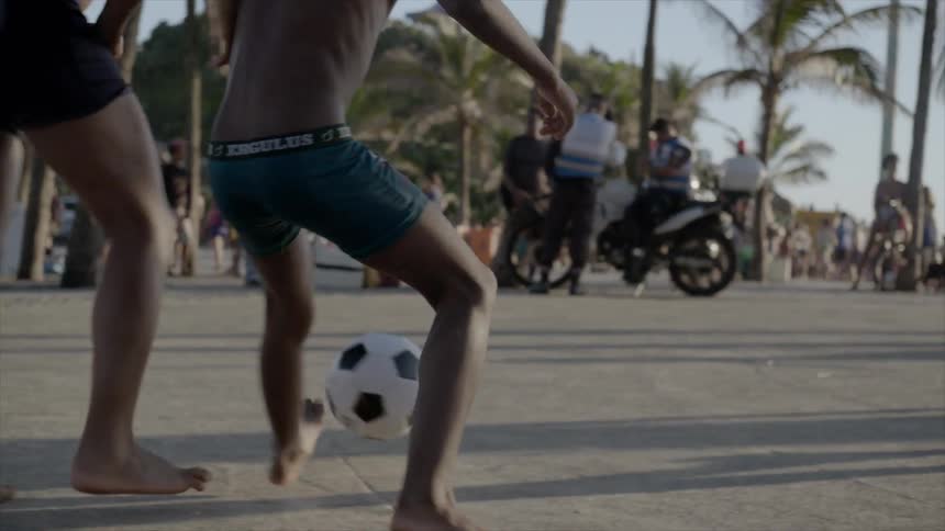 People play soccer on the concrete