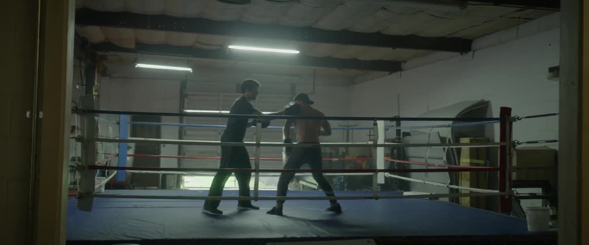 Two boxers spar in the ring