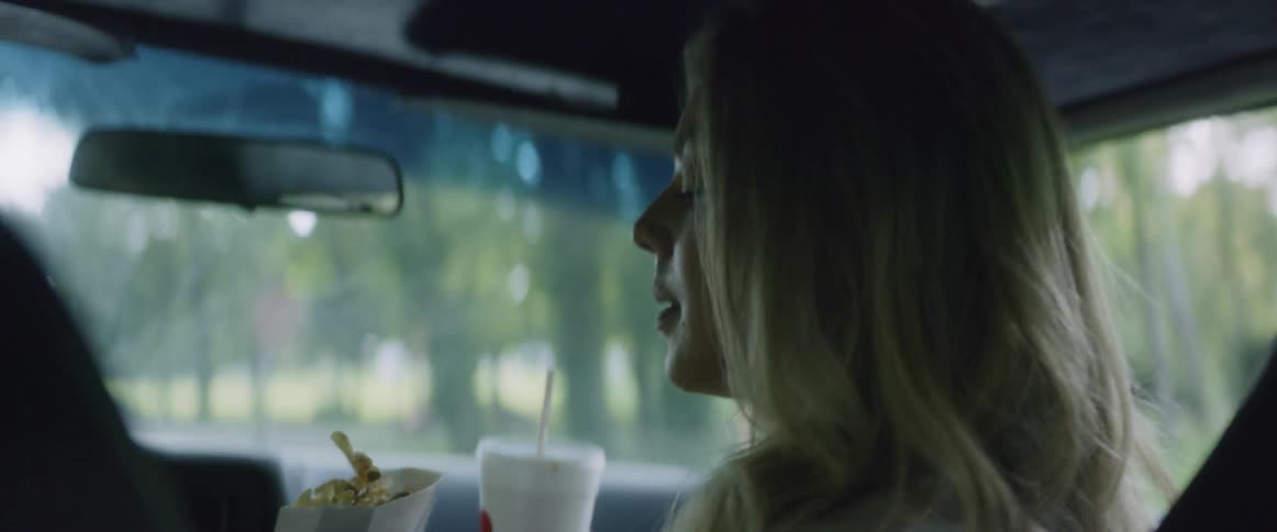 People are eating and driving in the car
