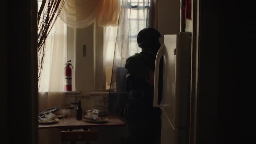 An officer goes into the corner searching around