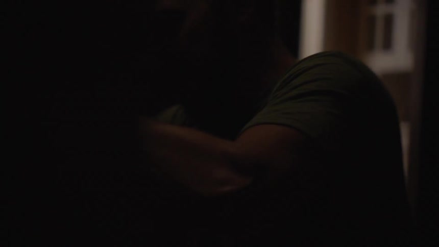 Person moves hands rapidly in dim light