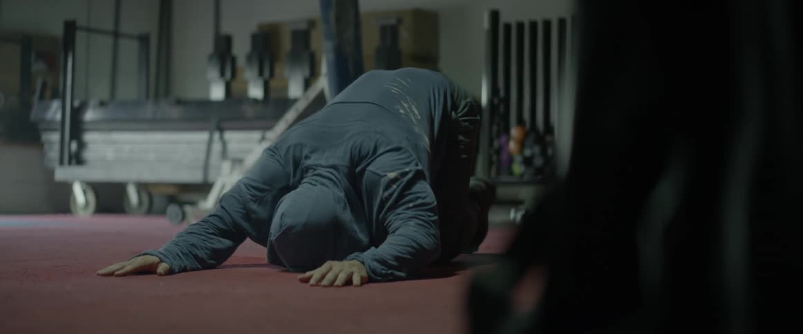A man stretches on a floor