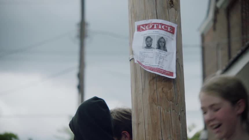A wanted sign hangs on a telephone pole