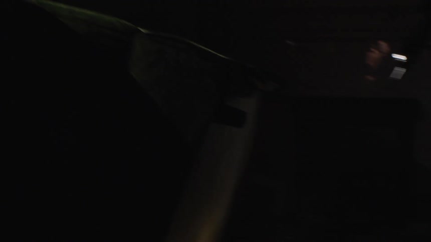 Light shines over furniture in a dark room