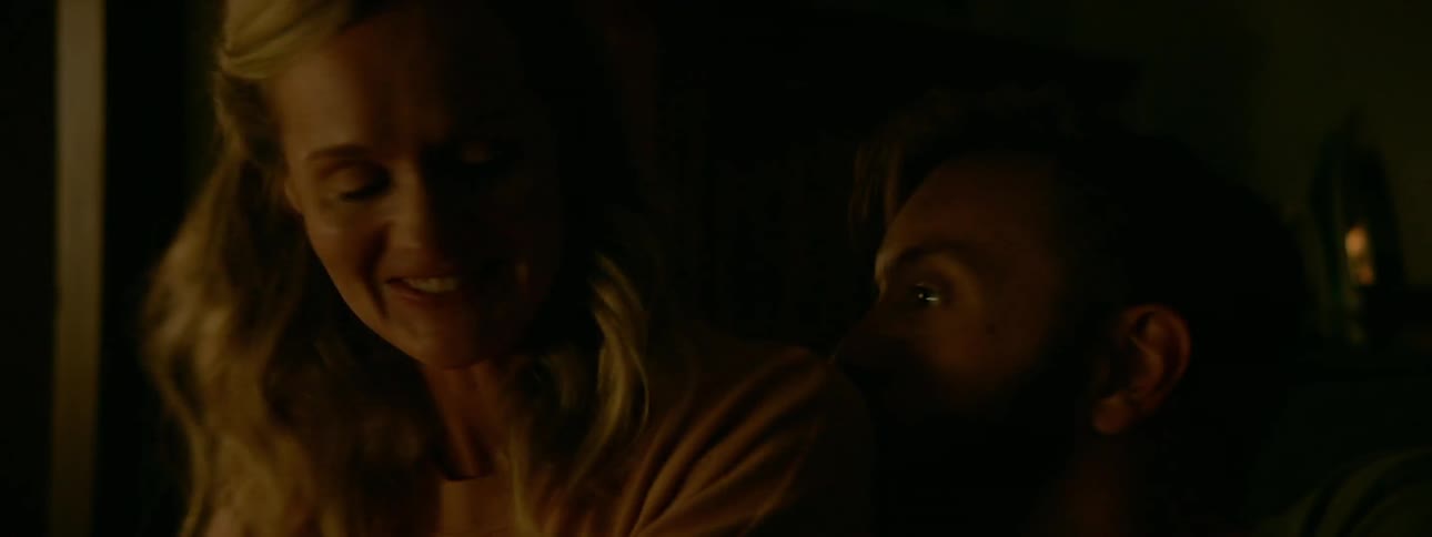 A man and woman flirt and hug