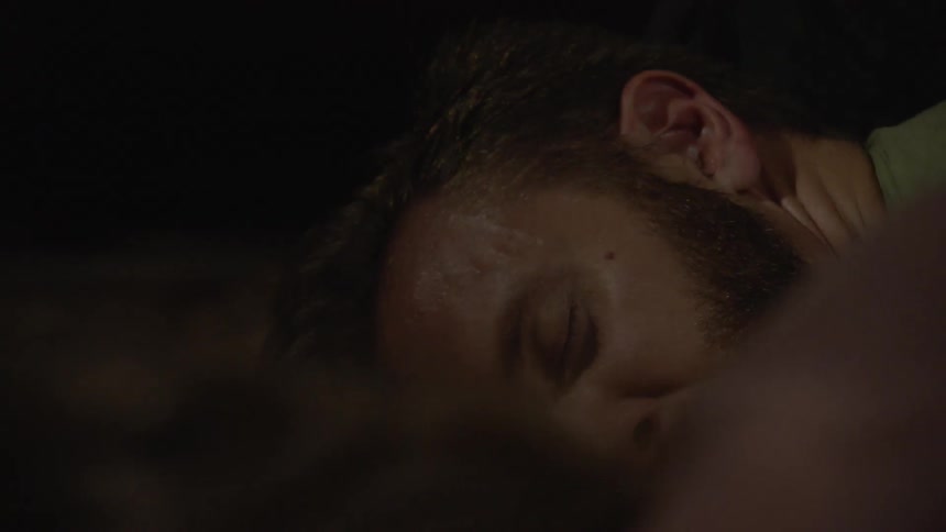 Two people on the ground are looking at each other in the dark