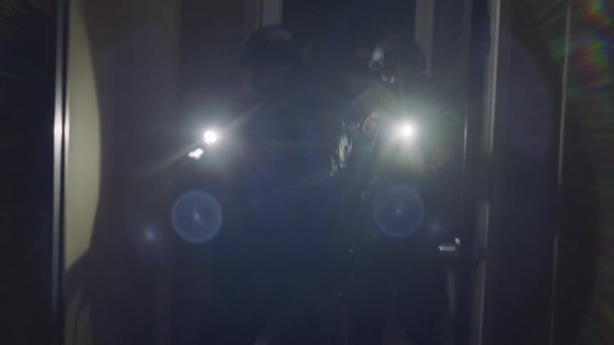Police storm into a house at night with rifles